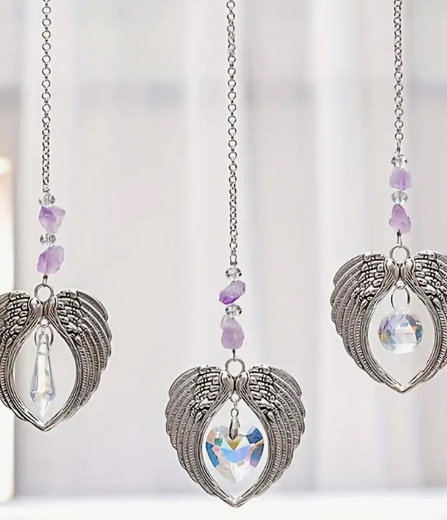Sun Catcher – Angel Wings with Purple Heart Crystal
A beautifully crafted sun catcher featuring delicate angel wings and a stunning purple & heart crystal. Perfect for adding a touch of elegance and positive energy to any room.